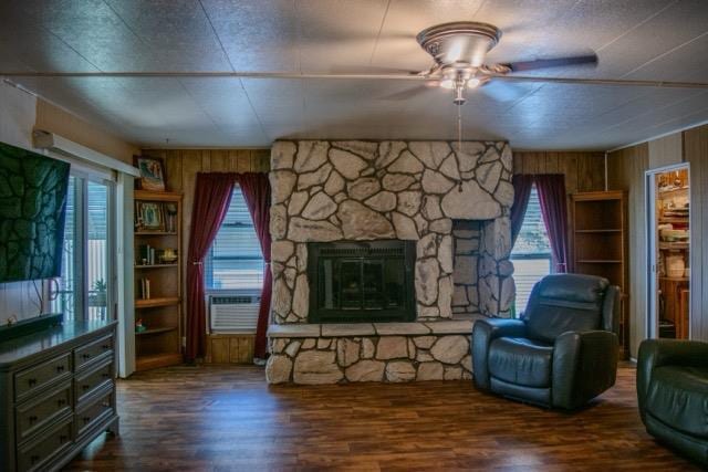 371 Bethel Ave Unit 62, Sanger, CA 93657 - living area featuring ceiling fan, wood walls, wood finished floors, and plenty of natural light