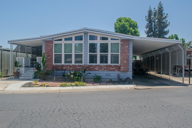 371 Bethel Ave Unit 62, Sanger, CA 93657 - manufactured / mobile home with brick siding and a carport