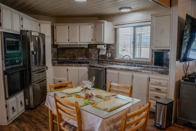 371 Bethel Ave Unit 62, Sanger, CA 93657 - kitchen with black appliances, wood ceiling, dark wood-style floors, white cabinets, and tasteful backsplash