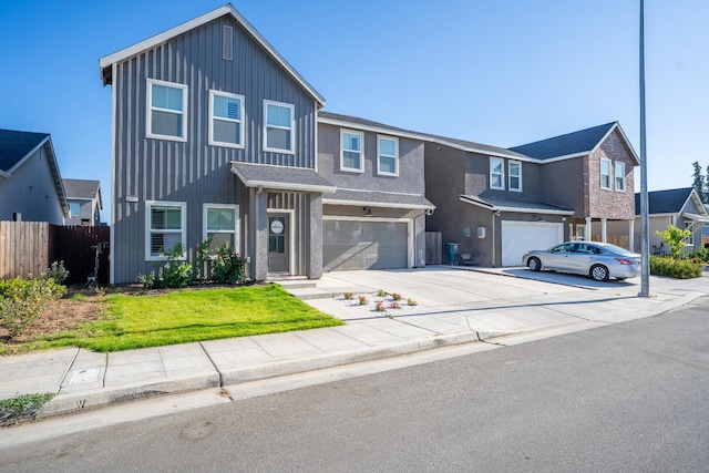 6569 E Lyell Ave, Fresno, CA 93727 - view of front of house with a garage, driveway, board and batten siding, and a residential view