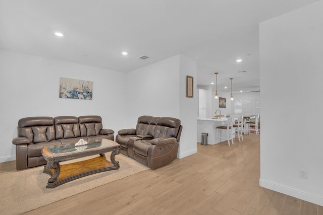 6569 E Lyell Ave, Fresno, CA 93727 - living room with light wood-type flooring and recessed lighting