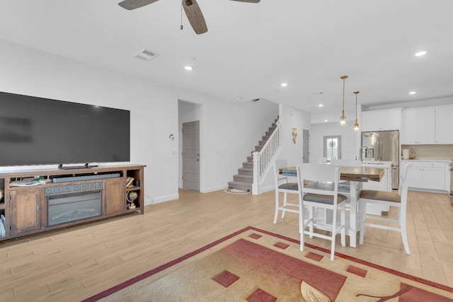 6569 E Lyell Ave, Fresno, CA 93727 - living area with light wood-style floors, stairs, ceiling fan, and recessed lighting