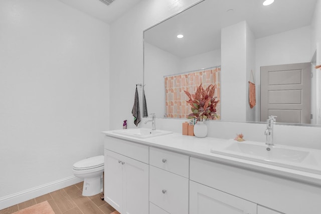 6569 E Lyell Ave, Fresno, CA 93727 - full bath with double vanity, recessed lighting, a shower with shower curtain, and wood finished floors