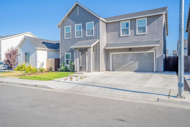 6569 E Lyell Ave, Fresno, CA 93727 - view of front of house featuring a garage, concrete driveway, and board and batten siding