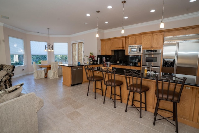 1622 E Shadow Crk, Fresno, CA 93730 - kitchen featuring built in appliances, custom range hood, dark countertops, a kitchen breakfast bar, and plenty of natural light