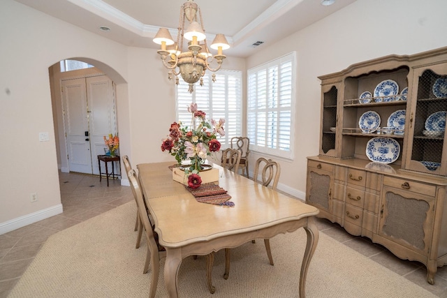1622 E Shadow Crk, Fresno, CA 93730 - dining room with arched walkways, a chandelier, a tray ceiling, light tile patterned floors, and ornamental molding