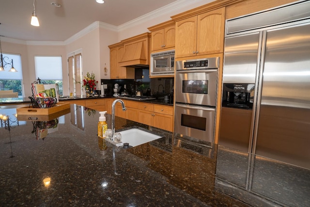 1622 E Shadow Crk, Fresno, CA 93730 - kitchen with built in appliances, crown molding, premium range hood, decorative light fixtures, and dark stone countertops
