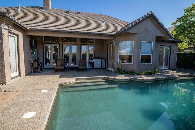 1622 E Shadow Crk, Fresno, CA 93730 - rear view of property with french doors, an outdoor pool, a patio, and stucco siding