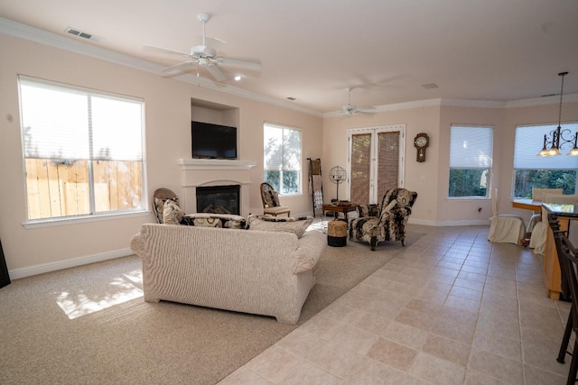 1622 E Shadow Crk, Fresno, CA 93730 - living room featuring ceiling fan, a glass covered fireplace, crown molding, light tile patterned flooring, and a chandelier