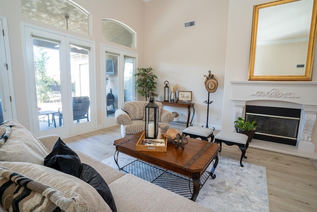 1622 E Shadow Crk, Fresno, CA 93730 - living room with french doors, plenty of natural light, wood finished floors, and a high ceiling