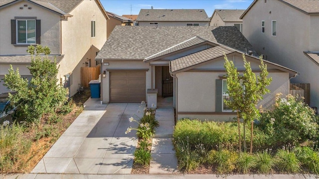 6105 W Richert Ave, Fresno, CA 93723 - view of front of property with stucco siding, concrete driveway, an attached garage, and a shingled roof