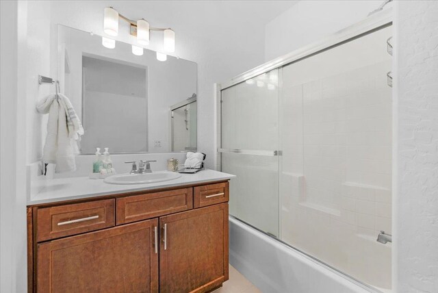 6105 W Richert Ave, Fresno, CA 93723 - bathroom with vanity and shower / bath combination with glass door