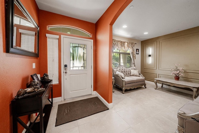 6712 W Lucas Dr, Fresno, CA 93722 - foyer entrance with arched walkways, light tile patterned floors, and recessed lighting