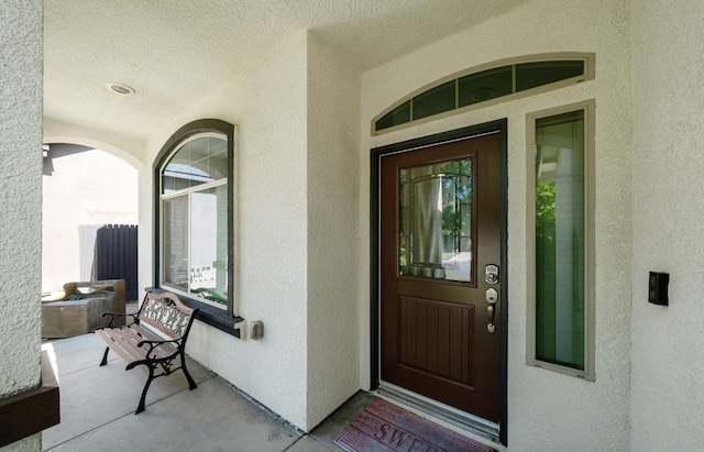 6712 W Lucas Dr, Fresno, CA 93722 - doorway to property featuring stucco siding