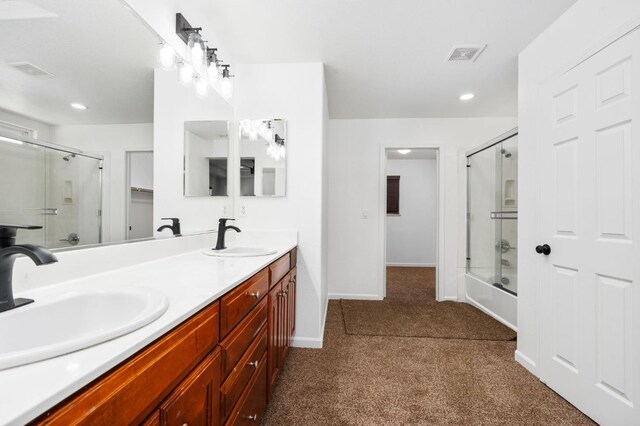5227 E Florence Ave, Fresno, CA 93727 - bathroom featuring double vanity, recessed lighting, carpet flooring, and enclosed tub / shower combo