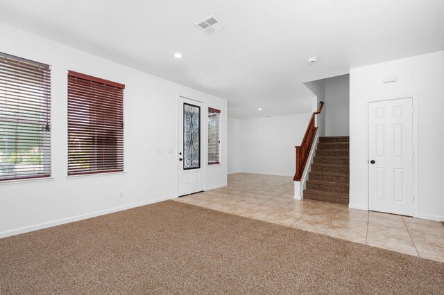 5227 E Florence Ave, Fresno, CA 93727 - entrance foyer with light colored carpet, stairs, recessed lighting, and light tile patterned flooring