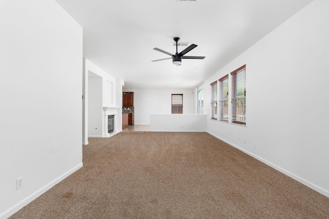 5227 E Florence Ave, Fresno, CA 93727 - unfurnished living room featuring light colored carpet, ceiling fan, and a fireplace