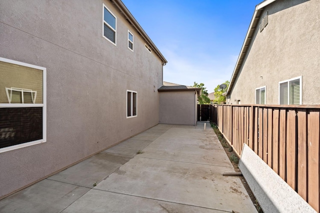 5227 E Florence Ave, Fresno, CA 93727 - view of side of home with a fenced backyard, a patio, and stucco siding