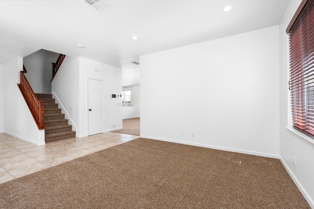 5227 E Florence Ave, Fresno, CA 93727 - spare room with light carpet, stairway, light tile patterned floors, and recessed lighting