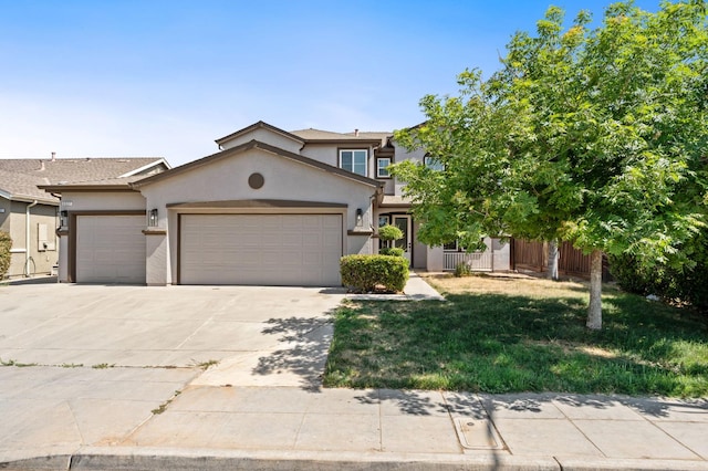 5227 E Florence Ave, Fresno, CA 93727 - view of front facade with a garage, stucco siding, and driveway
