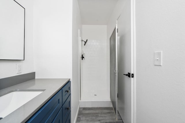 1428 N Knoll Ave, Fresno, CA 93722 - bathroom featuring a stall shower, vanity, and wood finished floors