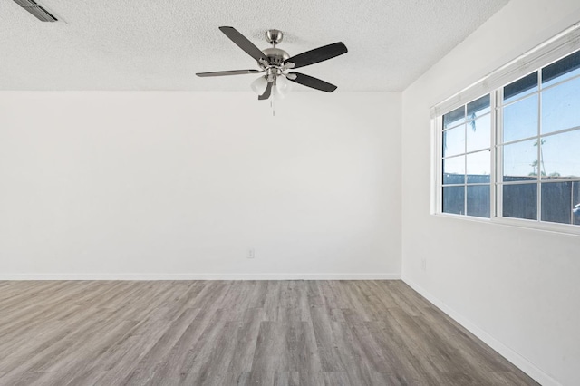 1428 N Knoll Ave, Fresno, CA 93722 - unfurnished room featuring wood finished floors, a textured ceiling, and ceiling fan