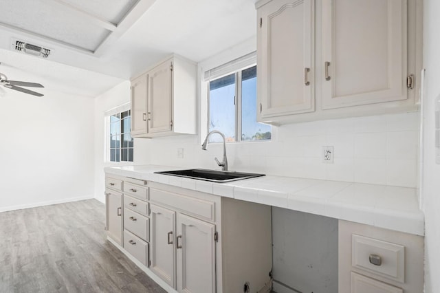 1428 N Knoll Ave, Fresno, CA 93722 - kitchen featuring backsplash, wood finished floors, and plenty of natural light