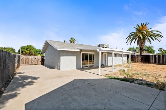 1428 N Knoll Ave, Fresno, CA 93722 - rear view of house with a fenced backyard, stucco siding, a patio, and a gate