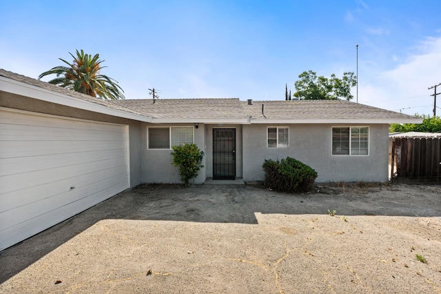 1428 N Knoll Ave, Fresno, CA 93722 - view of front facade with stucco siding, a garage, and roof with shingles