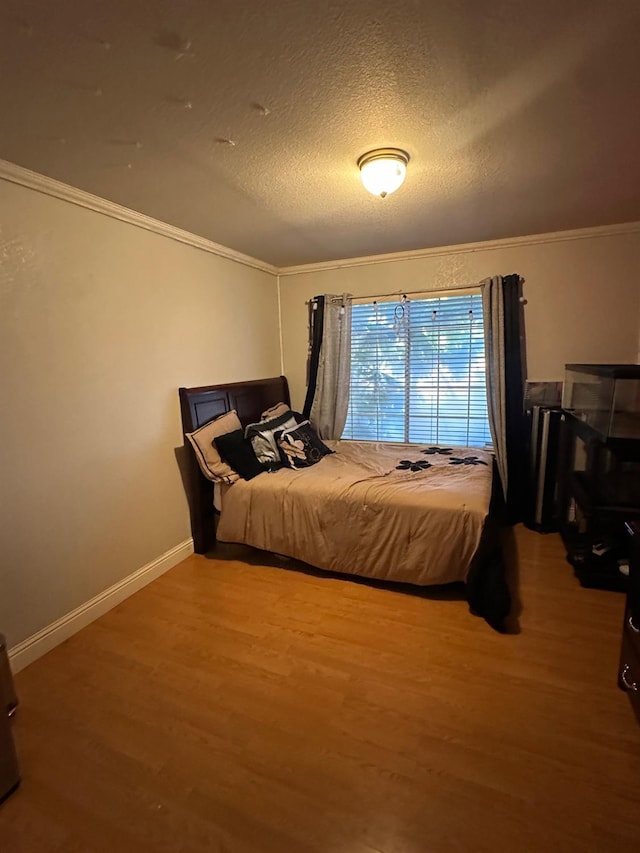 6675 N Lola Ave, Fresno, CA 93722 - bedroom featuring crown molding, wood finished floors, and a textured ceiling