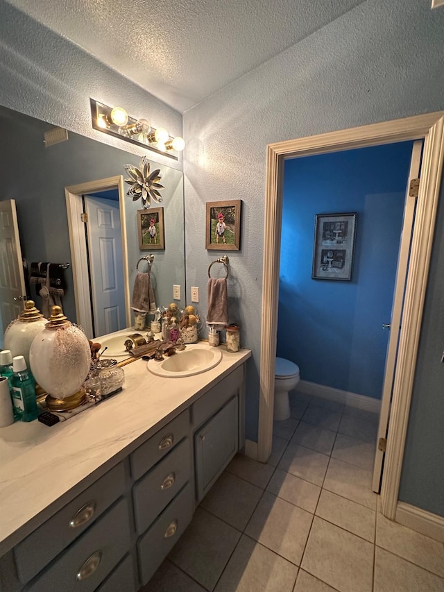 6675 N Lola Ave, Fresno, CA 93722 - bathroom with vanity, tile patterned floors, and a textured ceiling