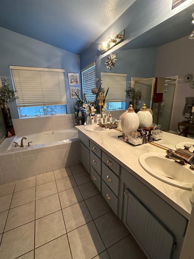 6675 N Lola Ave, Fresno, CA 93722 - full bathroom featuring double vanity, lofted ceiling, a bath, tile patterned flooring, and a shower stall