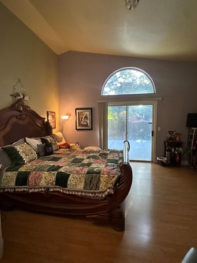 6675 N Lola Ave, Fresno, CA 93722 - bedroom with access to exterior, wood finished floors, and vaulted ceiling