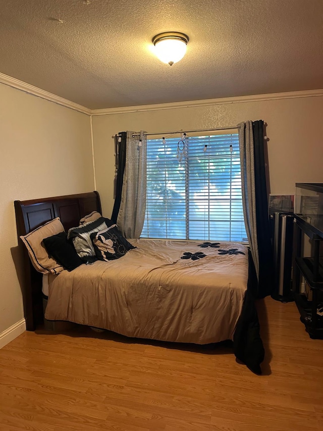 6675 N Lola Ave, Fresno, CA 93722 - bedroom featuring ornamental molding, a textured ceiling, and wood finished floors