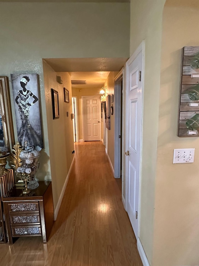 6675 N Lola Ave, Fresno, CA 93722 - corridor with wood finished floors and baseboards