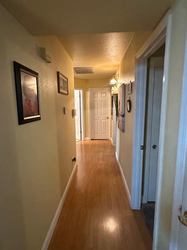6675 N Lola Ave, Fresno, CA 93722 - hall with light wood finished floors and baseboards