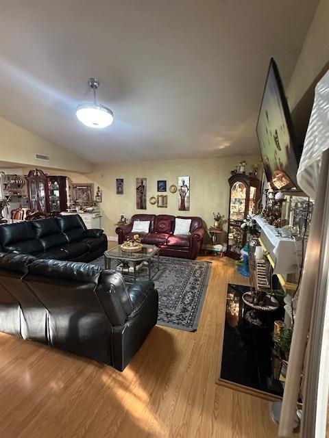 6675 N Lola Ave, Fresno, CA 93722 - living area featuring wood finished floors and lofted ceiling