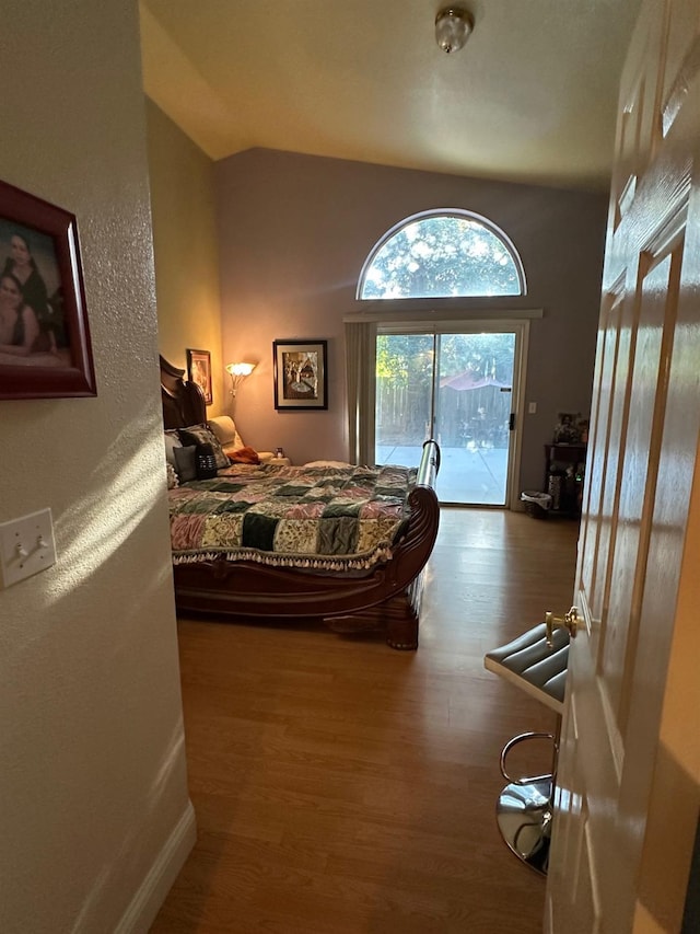 6675 N Lola Ave, Fresno, CA 93722 - bedroom with access to outside, wood finished floors, and vaulted ceiling