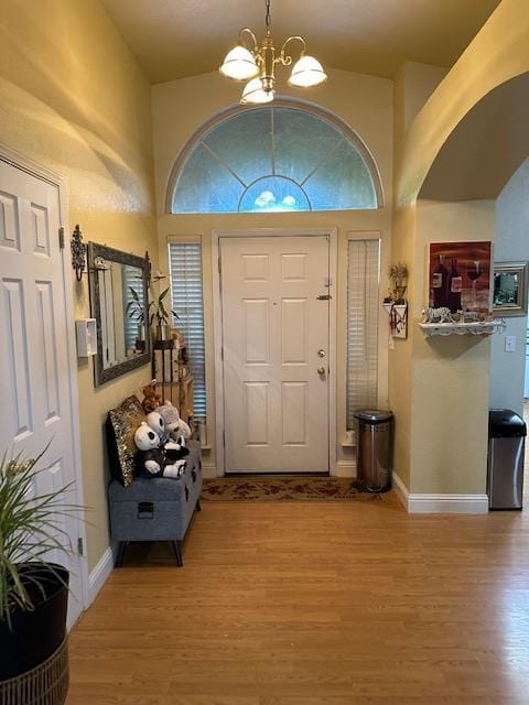 6675 N Lola Ave, Fresno, CA 93722 - foyer featuring a chandelier, light wood-type flooring, plenty of natural light, and a high ceiling