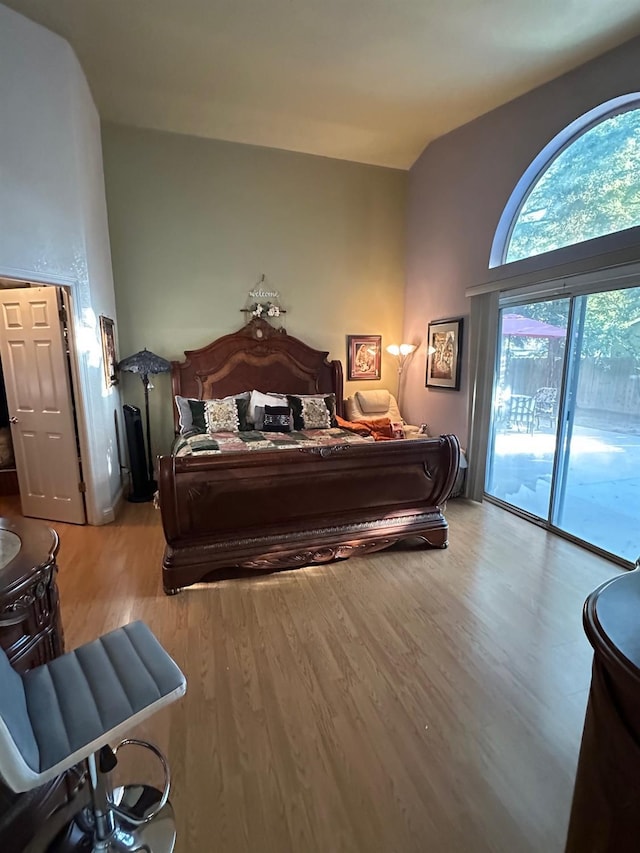 6675 N Lola Ave, Fresno, CA 93722 - bedroom with access to exterior and wood finished floors