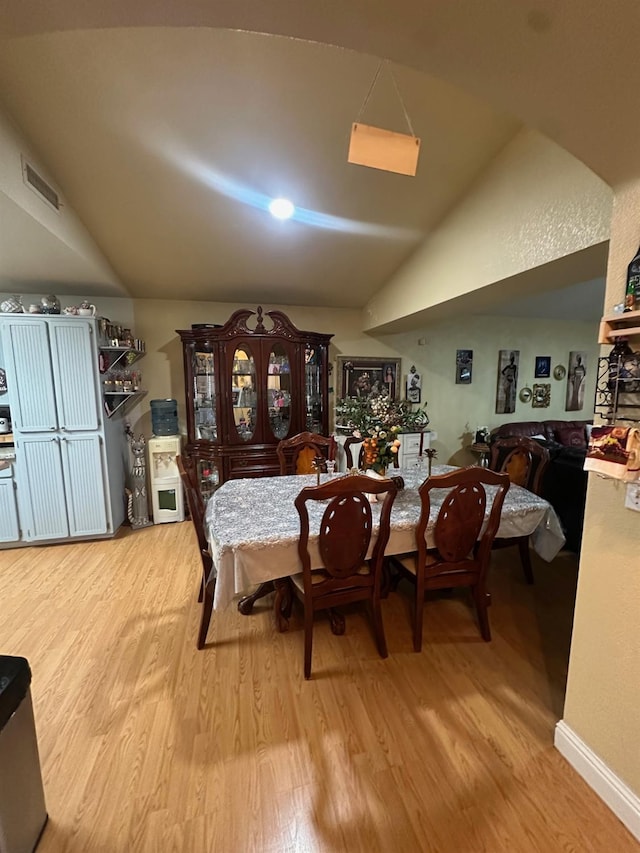 6675 N Lola Ave, Fresno, CA 93722 - dining area with wood finished floors and vaulted ceiling