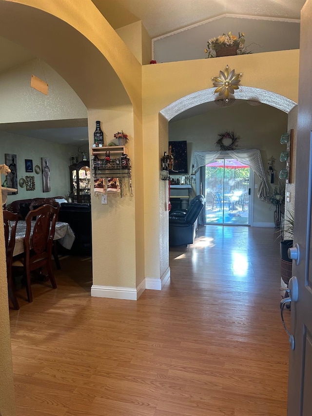 6675 N Lola Ave, Fresno, CA 93722 - hall with wood finished floors, lofted ceiling, and arched walkways