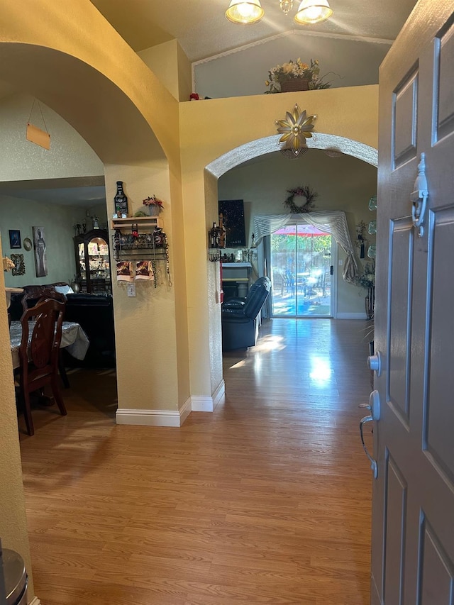 6675 N Lola Ave, Fresno, CA 93722 - foyer entrance featuring wood finished floors, vaulted ceiling, and arched walkways