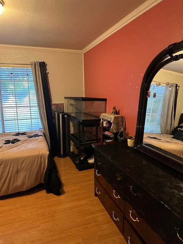 6675 N Lola Ave, Fresno, CA 93722 - bedroom featuring crown molding and light wood-type flooring