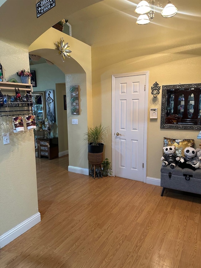 6675 N Lola Ave, Fresno, CA 93722 - corridor with arched walkways and wood finished floors