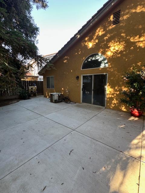 6675 N Lola Ave, Fresno, CA 93722 - view of home's exterior featuring stucco siding and a patio area