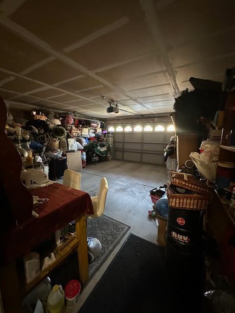 6675 N Lola Ave, Fresno, CA 93722 - garage featuring a garage door opener