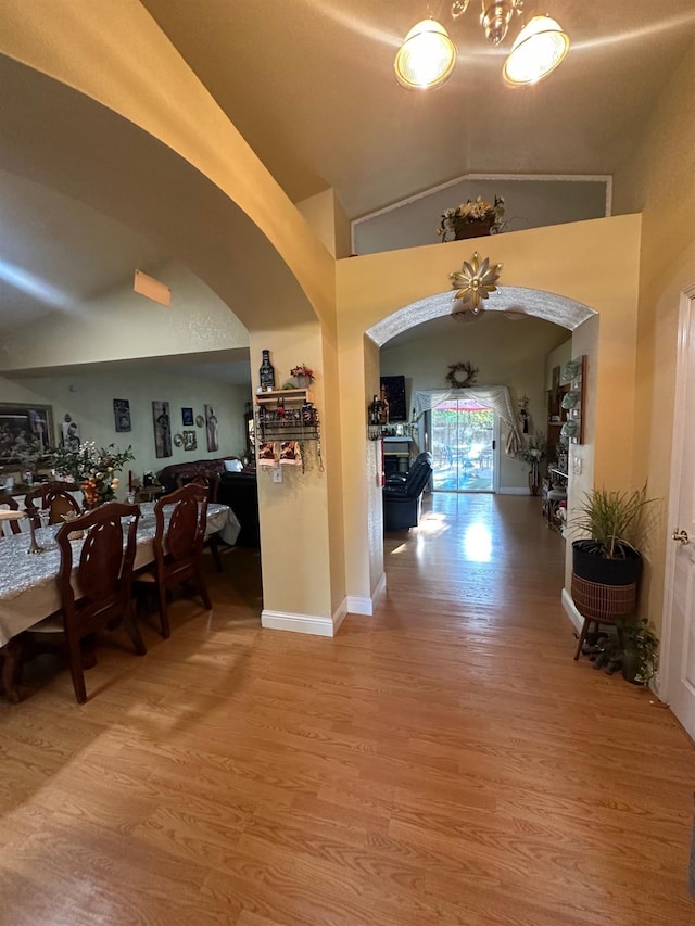 6675 N Lola Ave, Fresno, CA 93722 - corridor featuring arched walkways, wood finished floors, and vaulted ceiling