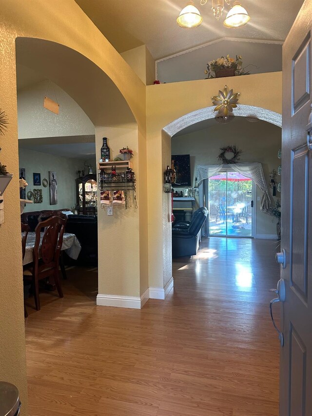 6675 N Lola Ave, Fresno, CA 93722 - foyer entrance featuring wood finished floors, lofted ceiling, and bar