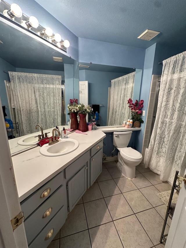 6675 N Lola Ave, Fresno, CA 93722 - full bath featuring vanity, tile patterned flooring, a textured ceiling, and a shower with shower curtain